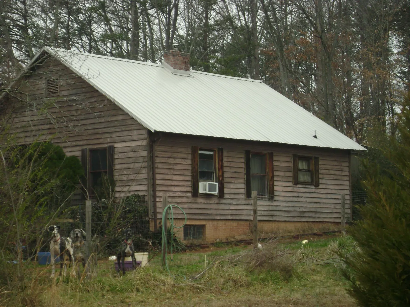 White metal roof on an old wood sided farmhouse, from a Metal Roof Installation job in Ogdensburg